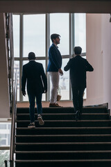  Business people standing in a corporate building. While discussing business ideas.