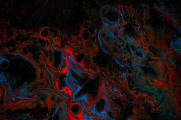 Texture in the style of fluid art. Abstract background with swirling paint effect. Liquid acrylic paint background. Black, blue and red colors.