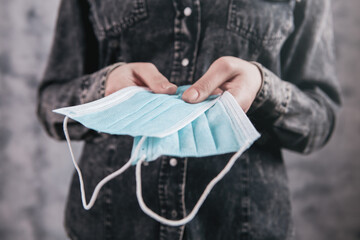 girl holding a medical mask in her hand