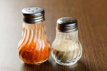 Ground chilli and pepper in glass bottle