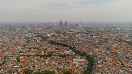 Fototapeta premium Aerial cityscape modern city Surabaya with skyscrapers, buildings and houses. urban environment in asia city skyline with skyscrapers and business centers java, indonesia