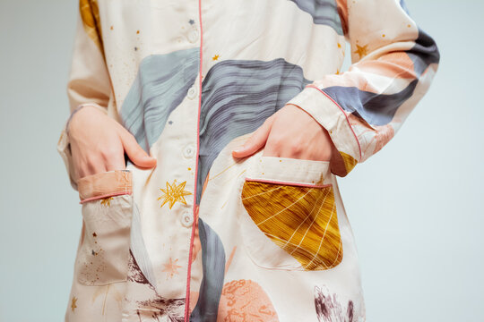 Beautiful booty of a young woman in fashionable beige pajamas