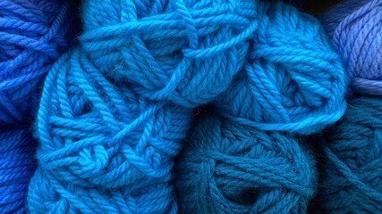 Blue and dark blue range of wool yarn. Multicolored skeins of wool close-up