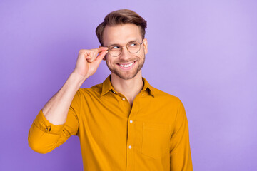 Portrait of cheerful person hand touch glasses toothy smile look empty space isolated on purple color background