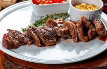 sliced grilled steak served , Picanha