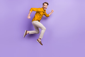 Fototapeta na wymiar Full length body size view portrait of nice funky glad cheerful guy jumping running isolated over violet purple color background