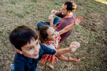 Happy kids running in front yard of house