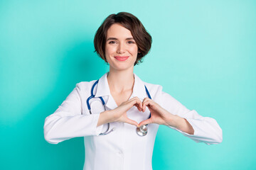 Photo of young woman happy positive smile show fingers hear sign medicine doctor isolated over teal color background