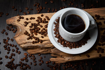 Obraz na płótnie Canvas Cup of coffee on a rustic wood. Coffee grains.