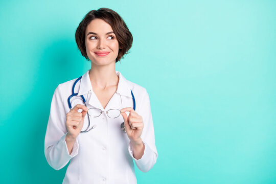 Photo portrait of cheerful female doctor wearing white uniform looking copyspace isolated bright teal color background
