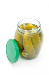 Pickled cucumbers in a glass jar on a white background