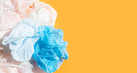 Fototapeta premium Crumpled plastic bags on orange background.