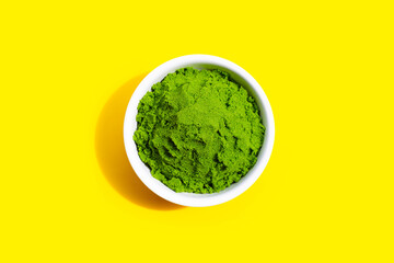 Wolffia globosa or Water Meal in white bowl on yellow background.