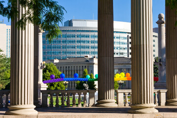 Civic Center Plaza Denver view between classical columns with gay pride balloon streamer on a...