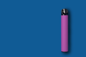 Disposable e-cigarette in purple color on blue isolated background. The concept of modern smoking, vaping and nicotine. Top view
