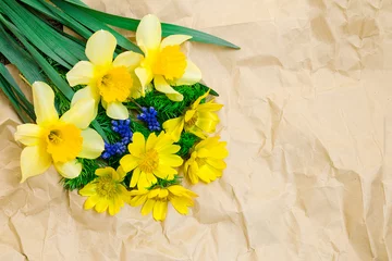  Spring flowers on the background of wrapping crumpled paper. © Improvisation