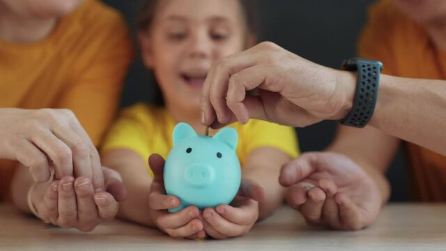 piggy bank. happy family a save money. business investment finance piggy bank concept. happy family hands holding piggy bank. kid and parents put lifestyle coins in investment money box