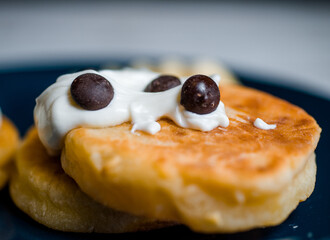 cooking small pancakes with delicious natural egg filling with cottage cheese, fry them in a pan and serve on a plate