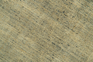 dark creative background: reverse side of black-primed linen canvas, uneven lighting, color toning