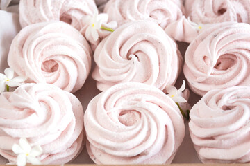 Close up of zephyr marshmallow decorated by flowers.