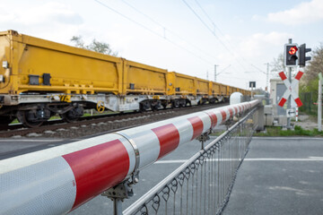 Selective focus view at red and white level crossing railway barrier which block the road and...