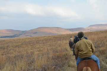 Group of Indian Horse riding riders on a trail in Drakensberg region in South Africa