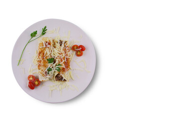 Pancakes with meat, in tomato sauce and cheese, with cilantro and grated cheese on top, and some cherry tomatoes on the plate. Top view on white background.