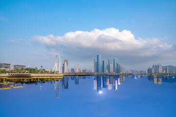 Naklejka premium Mirroring scenery of Qianhai CBD in Shenzhen, China during day and night