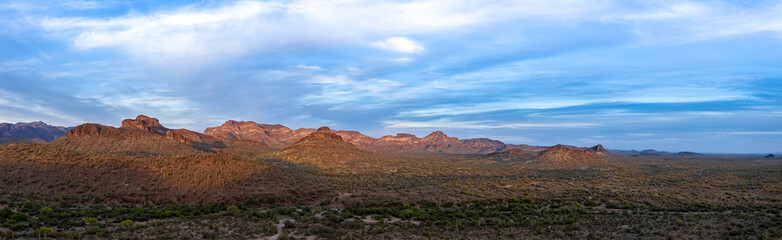 Fototapeta na wymiar Early evening sun shining on the desert mountains