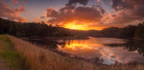 Fototapeta na wymiar Stunning Panoramic Lakeside Sunset with Reflections