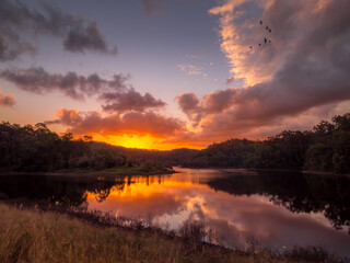 Fototapeta na wymiar Dramatic Lakeside Sunset with Reflections
