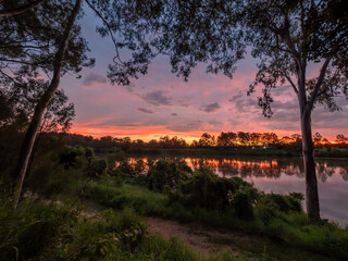 Naklejka premium Colourful Riverside Sunset with Reflections