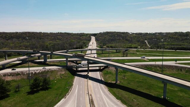 Following aerial speeded shot of a sunny busy traffic highway interchanges. Birds view. High quality 4k footage