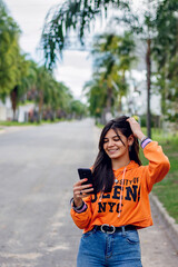 Young woman reading a message on the phone smil