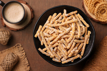 Madhura Seva Kerala fried snacks sweet food and Indian milk tea masala chai Tamil Nadu South India Sri Lanka. Kerala tea time food fried in coconut oil. Top view of  Indian festival snack .