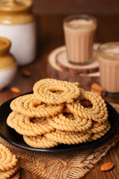 Rice murukku , savoury , chakli, chakali Indian milk tea chai Kerala snack deep fried coconut oil traditional South Indian Tamil Nadu India, Sri Lanka,   Onam, Vishu, Diwali Deepawali, Pongal, Eid