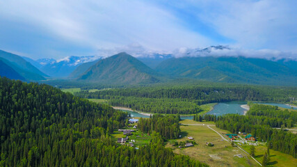 Aerial view of the Kucherla river valley overlooking the farm, forest and mountain ridge, Altai photo by drone