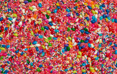 Fototapeta na wymiar jelly beans jellybean candy and sprinkles food background with various covers and flavors