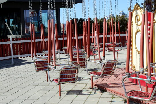 Empty children`s merry-go-rounds are waiting in the wings