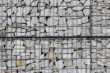 Marble small stones are beautifully laid out in a checkered iron mesh