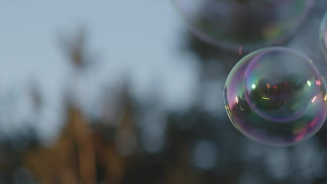 Girl Blowing Bubbles That Float Away
