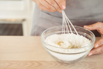 Woman Hand Mixed Batter on Clear Bowl with Baloon Whisk Step by Step Baking Preparation in the Kitchen