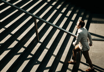 Business and people concept: Young Business man going up the stairs