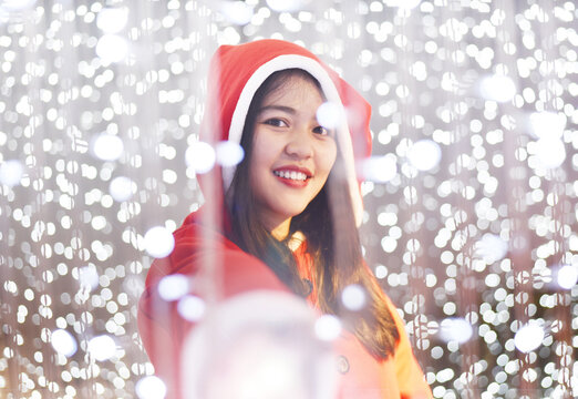 young Asian woman with night light Christmas fastival background