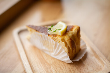 Cake and lemon on a wooden plate