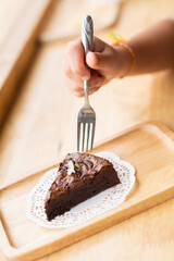 Close up of a girl eating a brownie cake