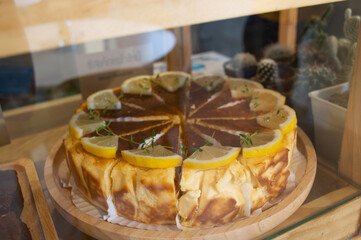 Cake and lemon on a wooden plate