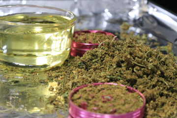 Closeup of vegetable oil to be infused with decarboxylated cannabis flowers and leaves
