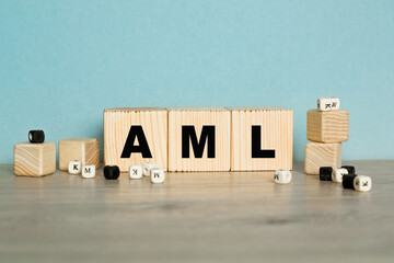 the word AML are written on a wooden cubes structure. Cube on a bright background. Can be used for business, financial concept. Selective focus. copy space