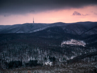 Dark mountain morning, winter lanscape with snow in the woods